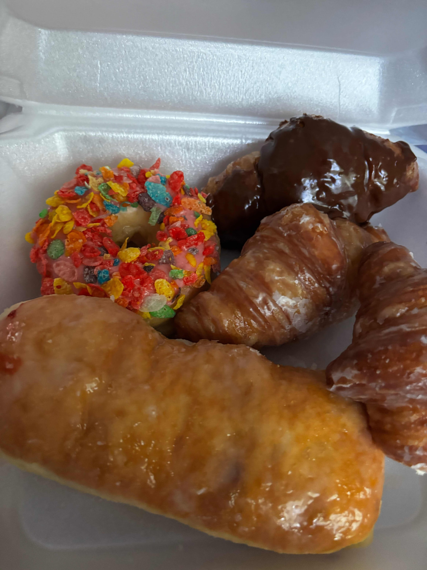 A fruity-cereal donut with glazed and chocolate croissants